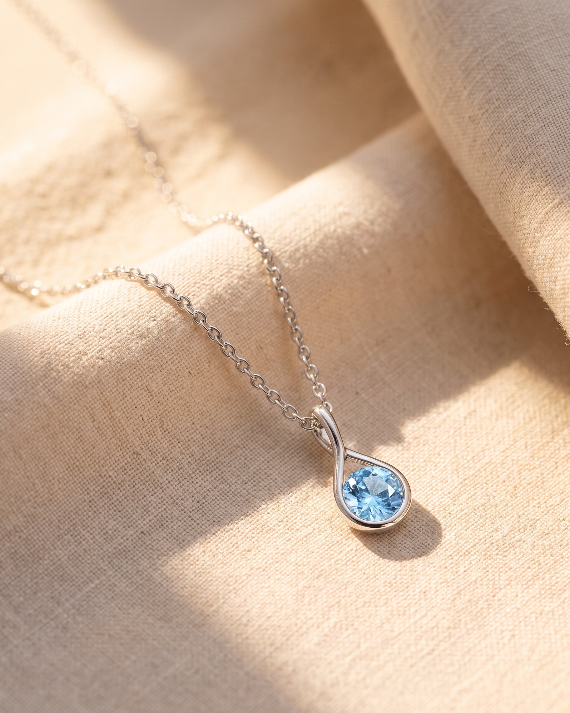 Mayfair Aquamarine Twist Pendant on linen