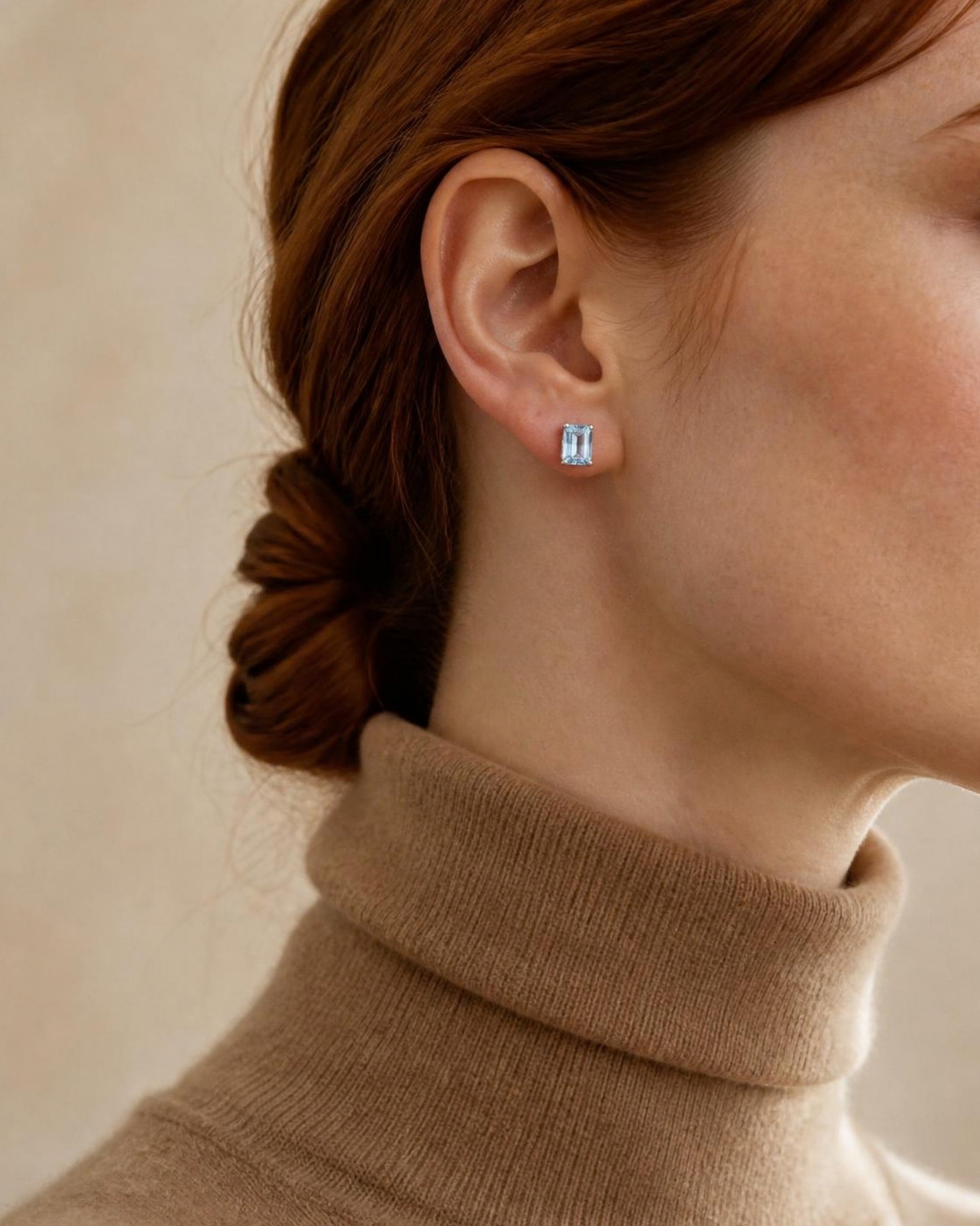 Louvre emerald cut aquamarine stud worn, camel turtleneck