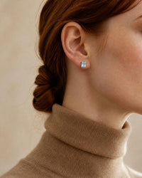 Louvre emerald cut aquamarine stud worn, camel turtleneck